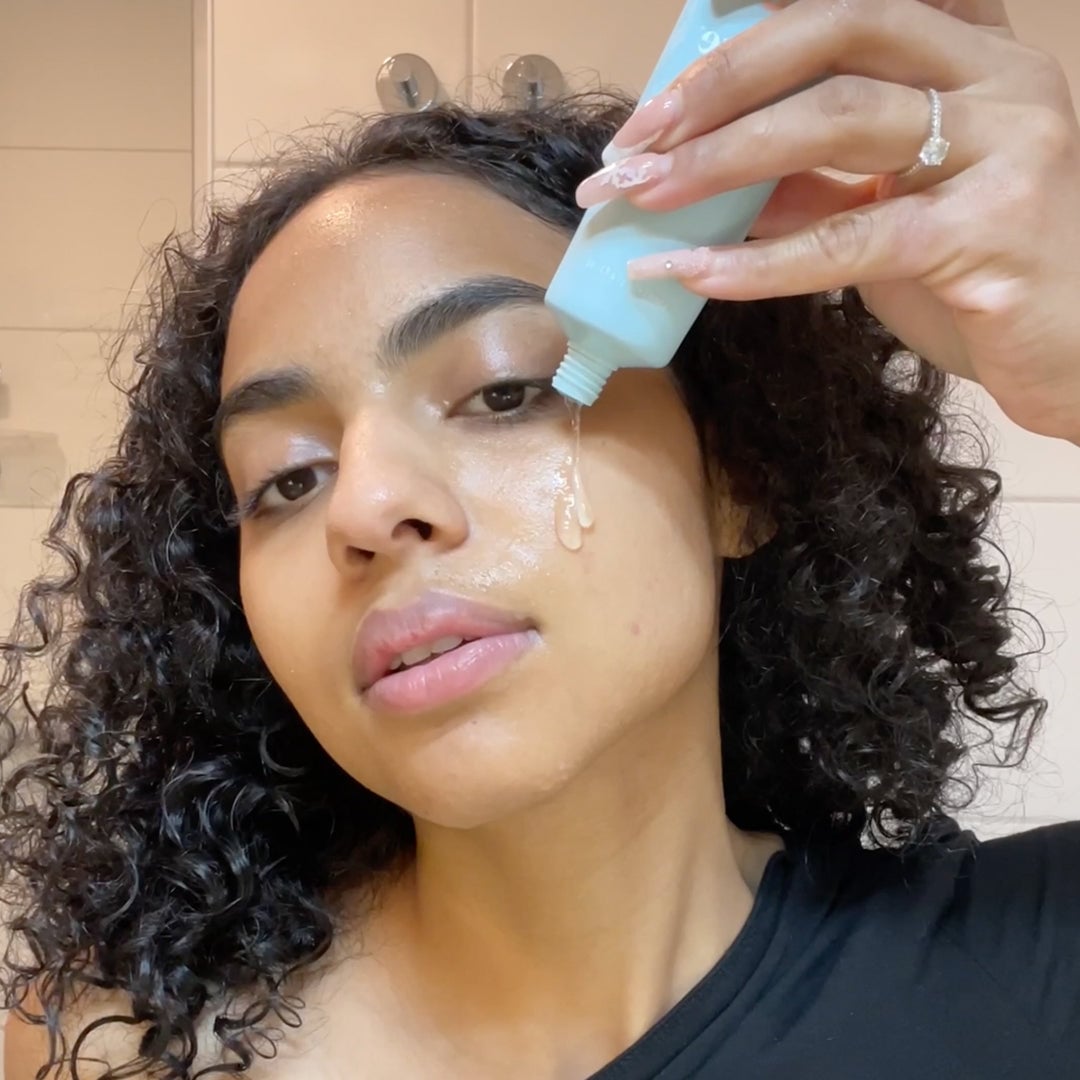 Person applying light blue gel product to face with clear liquid dripping