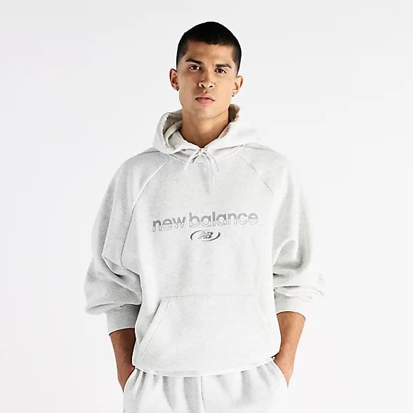 Man wearing white hoodie with text logo and matching sweatpants